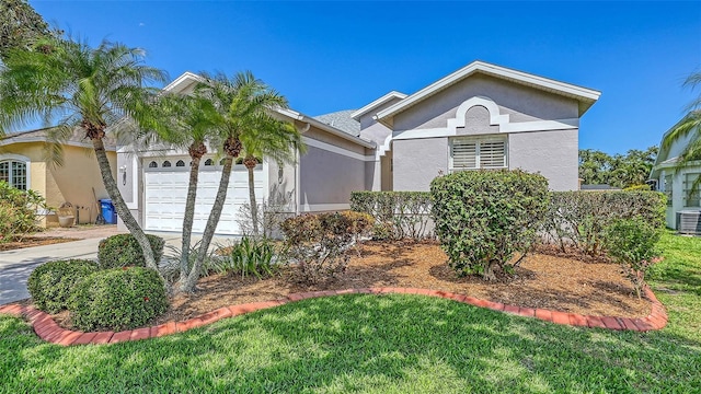 4208 Balmoral Way, Sarasota, FL 34238 - ranch-style house with an attached garage, stucco siding, cooling unit, concrete driveway, and a front lawn