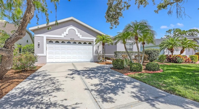 4208 Balmoral Way, Sarasota, FL 34238 - single story home with concrete driveway, an attached garage, stucco siding, and a front yard