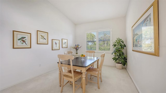 4208 Balmoral Way, Sarasota, FL 34238 - dining area featuring light colored carpet, baseboards, and vaulted ceiling
