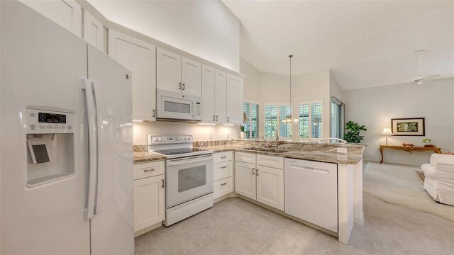 4208 Balmoral Way, Sarasota, FL 34238 - kitchen featuring white appliances, a sink, a peninsula, open floor plan, and white cabinetry