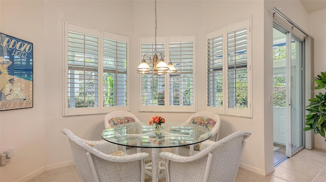 4208 Balmoral Way, Sarasota, FL 34238 - dining space featuring tile patterned floors, a chandelier, and baseboards