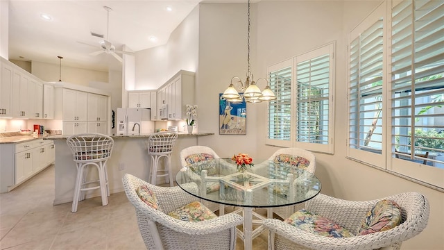 4208 Balmoral Way, Sarasota, FL 34238 - dining space with a high ceiling, a ceiling fan, a chandelier, and recessed lighting