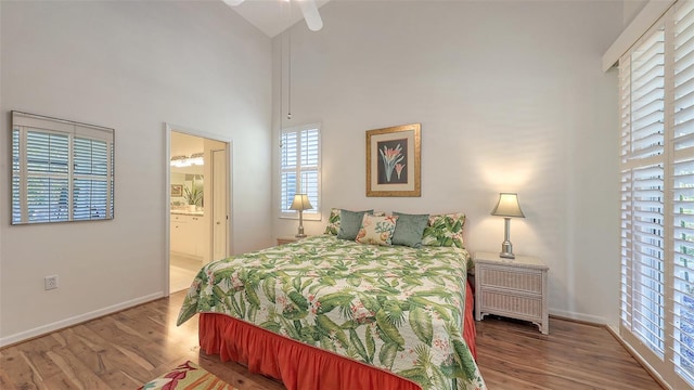 4208 Balmoral Way, Sarasota, FL 34238 - bedroom featuring wood finished floors, multiple windows, a towering ceiling, and baseboards