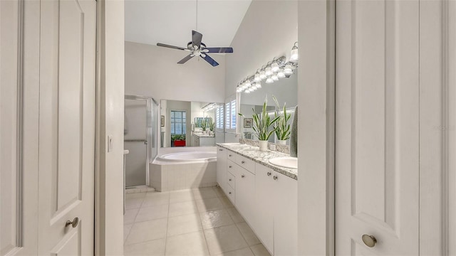 4208 Balmoral Way, Sarasota, FL 34238 - bathroom with double vanity, a bath, a stall shower, tile patterned floors, and ceiling fan