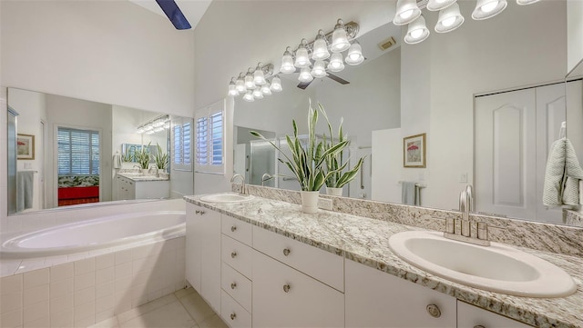 4208 Balmoral Way, Sarasota, FL 34238 - bathroom with double vanity, a garden tub, and tile patterned floors