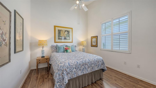 4208 Balmoral Way, Sarasota, FL 34238 - bedroom featuring baseboards, wood finished floors, a high ceiling, and a ceiling fan
