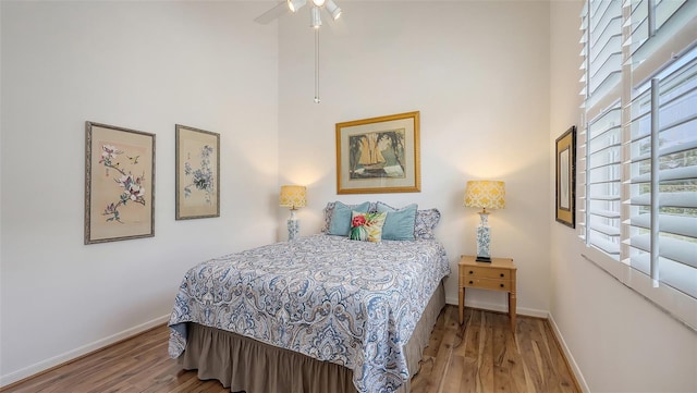 4208 Balmoral Way, Sarasota, FL 34238 - bedroom with a high ceiling, baseboards, and wood finished floors