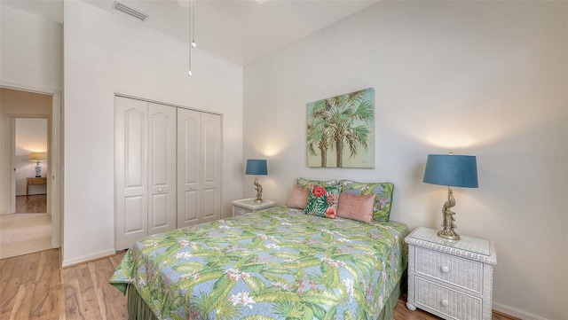 4208 Balmoral Way, Sarasota, FL 34238 - bedroom with a closet, wood finished floors, a towering ceiling, and baseboards