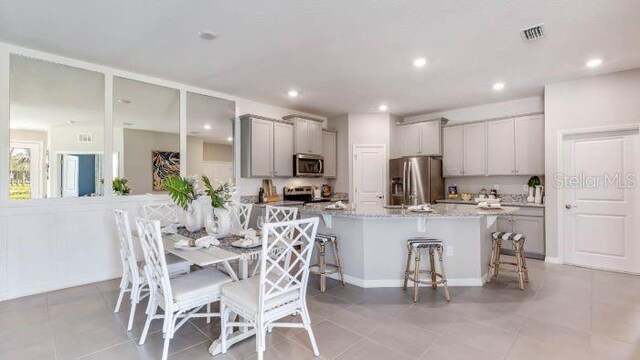 18114 Cropside Trl, Lakewood Ranch, FL 34211 - dining space featuring light tile patterned floors and recessed lighting