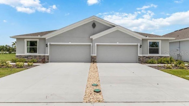 18105 Cropside Trl, Lakewood Ranch, FL 34211 - ranch-style home with stone siding, a garage, driveway, and stucco siding