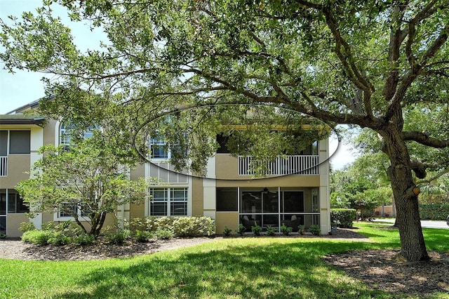 6552 Moorings Point Cir Unit 201, Lakewood Ranch, FL 34202 - rear view of house featuring a balcony, stucco siding, and a yard