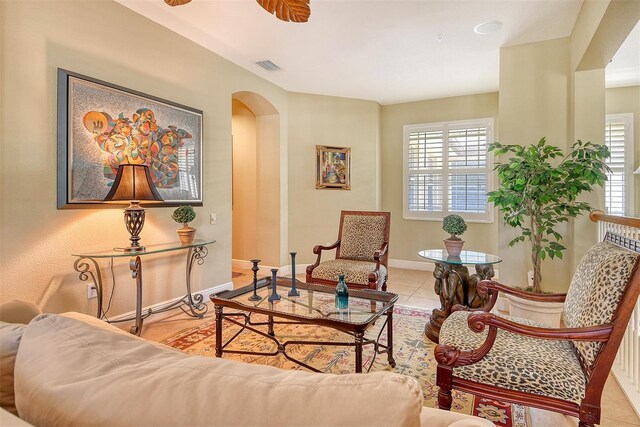 6552 Moorings Point Cir Unit 201, Lakewood Ranch, FL 34202 - living area featuring arched walkways, baseboards, and tile patterned floors