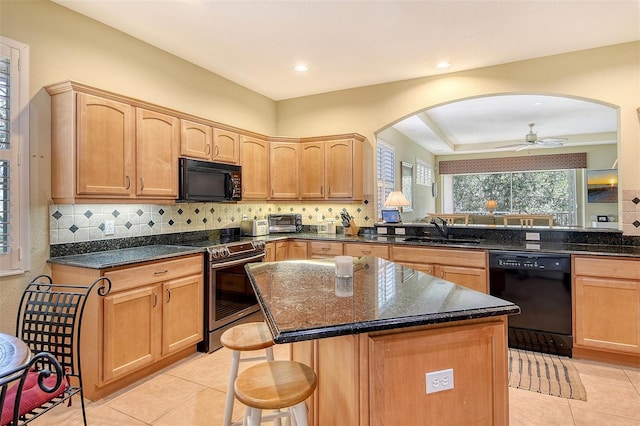 6552 Moorings Point Cir Unit 201, Lakewood Ranch, FL 34202 - kitchen featuring black appliances, a sink, arched walkways, light tile patterned floors, and recessed lighting