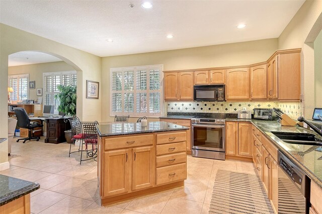 6552 Moorings Point Cir Unit 201, Lakewood Ranch, FL 34202 - kitchen featuring stainless steel range with electric stovetop, black microwave, dishwashing machine, a sink, and dark stone counters