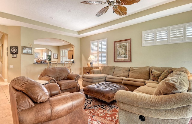 6552 Moorings Point Cir Unit 201, Lakewood Ranch, FL 34202 - living area featuring arched walkways, a ceiling fan, and light tile patterned floors