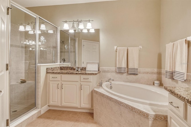 6552 Moorings Point Cir Unit 201, Lakewood Ranch, FL 34202 - bathroom with vanity, a shower stall, a garden tub, and tile patterned flooring
