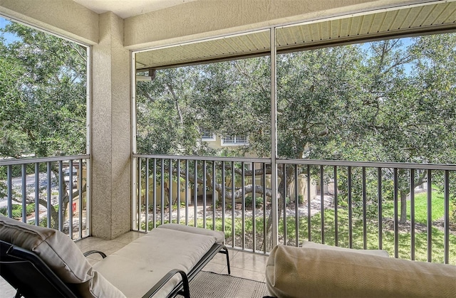 6552 Moorings Point Cir Unit 201, Lakewood Ranch, FL 34202 - sunroom with healthy amount of natural light and view of wooded area