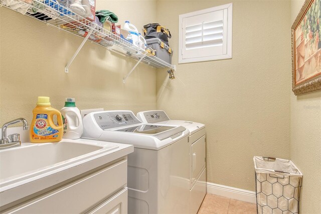 6552 Moorings Point Cir Unit 201, Lakewood Ranch, FL 34202 - washroom featuring separate washer and dryer, light tile patterned floors, and baseboards