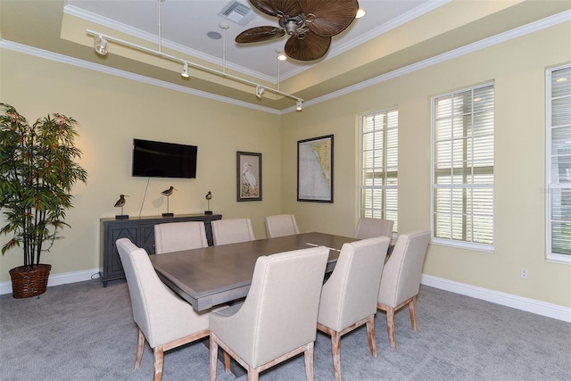 6552 Moorings Point Cir Unit 201, Lakewood Ranch, FL 34202 - carpeted dining space featuring rail lighting, healthy amount of natural light, ornamental molding, ceiling fan, and baseboards