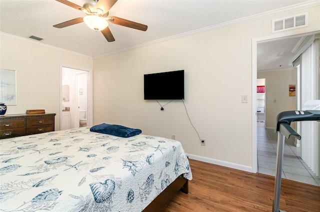 716 SE 12th Ct Unit 31, Cape Coral, FL 33990 - bedroom with ornamental molding, wood finished floors, baseboards, a ceiling fan, and connected bathroom