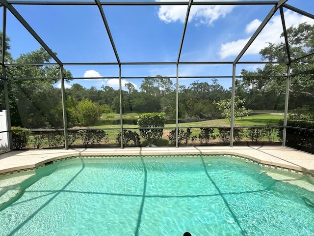 13809 18th Pl E, Bradenton, FL 34212 - outdoor pool with glass enclosure, view of wooded area, and a patio