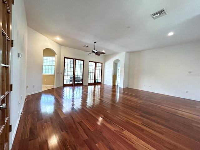 13809 18th Pl E, Bradenton, FL 34212 - unfurnished living room with arched walkways, wood finished floors, french doors, ceiling fan, and recessed lighting
