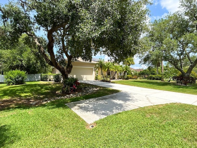 13809 18th Pl E, Bradenton, FL 34212 - view of property hidden behind natural elements with concrete driveway and an attached garage
