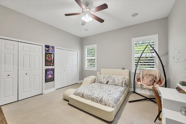 15208 21st Ave E, Bradenton, FL 34212 - bedroom featuring two closets, baseboards, and ceiling fan