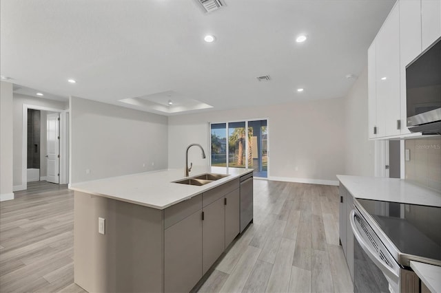 2258 Margaret Ln, North Port, FL 34286 - kitchen with stainless steel appliances, light wood finished floors, light countertops, white cabinetry, and recessed lighting