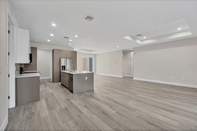 2258 Margaret Ln, North Port, FL 34286 - kitchen featuring appliances with stainless steel finishes, light countertops, recessed lighting, an island with sink, and light wood-type flooring