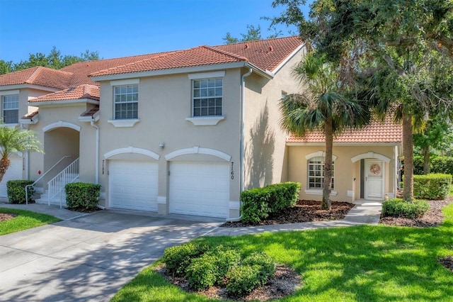 7160 Cedar Hollow Cir, Bradenton, FL 34203 - mediterranean / spanish-style house with a tile roof, stucco siding, an attached garage, and driveway