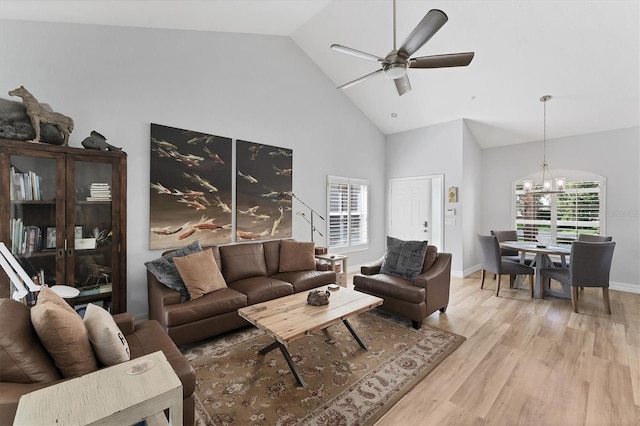 7160 Cedar Hollow Cir, Bradenton, FL 34203 - living area featuring high vaulted ceiling, light wood-type flooring, a chandelier, ceiling fan, and baseboards