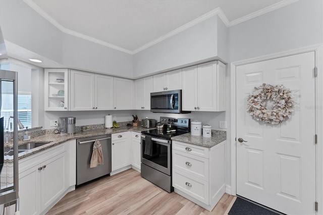 7160 Cedar Hollow Cir, Bradenton, FL 34203 - kitchen featuring appliances with stainless steel finishes, light stone countertops, light wood-style floors, white cabinets, and crown molding
