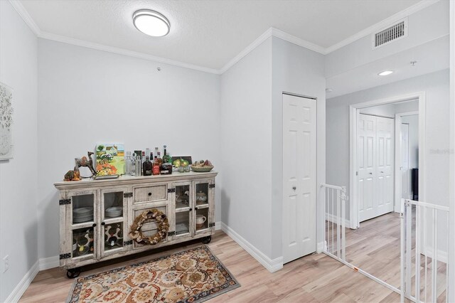 7160 Cedar Hollow Cir, Bradenton, FL 34203 - bar area with wood finished floors, ornamental molding, and baseboards