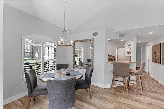 7160 Cedar Hollow Cir, Bradenton, FL 34203 - dining space featuring light wood-style flooring, a chandelier, plenty of natural light, and lofted ceiling