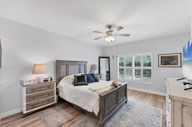 7160 Cedar Hollow Cir, Bradenton, FL 34203 - bedroom with baseboards, light wood-style flooring, and a ceiling fan