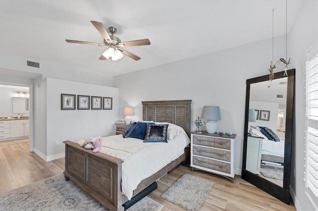 7160 Cedar Hollow Cir, Bradenton, FL 34203 - bedroom with light wood-style floors, baseboards, ensuite bathroom, and ceiling fan