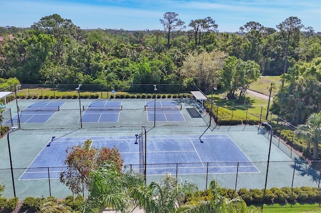 7160 Cedar Hollow Cir, Bradenton, FL 34203 - view of tennis court with a wooded view