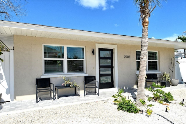 2908 Gulf Dr, Holmes Beach, FL 34217 - property entrance featuring stucco siding and covered porch