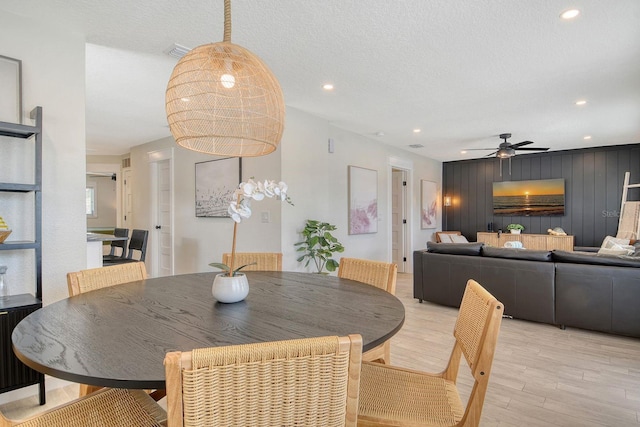 2908 Gulf Dr, Holmes Beach, FL 34217 - dining room featuring light wood finished floors, a ceiling fan, a textured ceiling, and recessed lighting