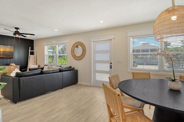 2908 Gulf Dr, Holmes Beach, FL 34217 - living room featuring light wood-style flooring, a textured ceiling, baseboards, ceiling fan, and recessed lighting