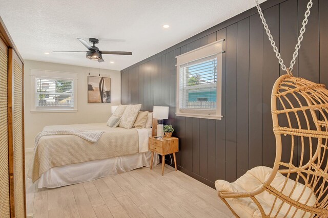 2908 Gulf Dr, Holmes Beach, FL 34217 - bedroom with wood finished floors, multiple windows, ceiling fan, recessed lighting, and a closet
