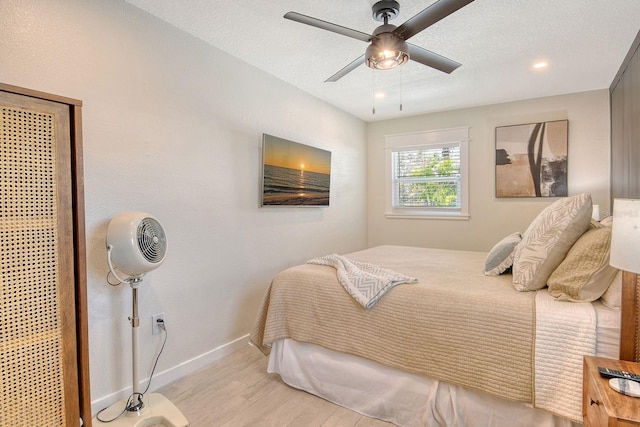 2908 Gulf Dr, Holmes Beach, FL 34217 - bedroom with light wood-style flooring, baseboards, and a ceiling fan