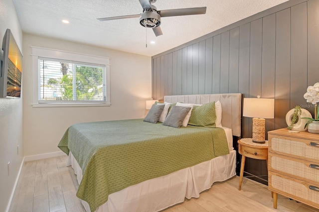 2908 Gulf Dr, Holmes Beach, FL 34217 - bedroom featuring light wood-style flooring, a textured ceiling, baseboards, ceiling fan, and recessed lighting