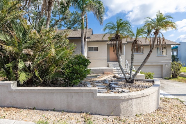 5912 Riverview Ln, Bradenton, FL 34209 - view of front facade with concrete driveway, stucco siding, and an attached garage