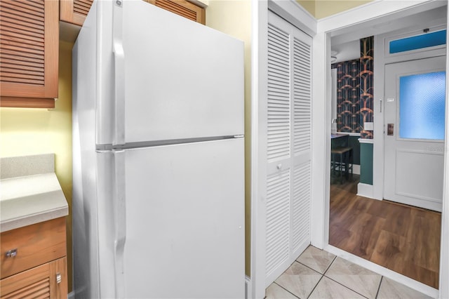 1221 N Palm Ave Unit 303, Sarasota, FL 34236 - kitchen featuring freestanding refrigerator, light countertops, and light tile patterned floors