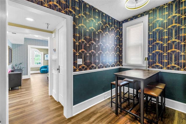 1221 N Palm Ave Unit 303, Sarasota, FL 34236 - dining room with wallpapered walls, baseboards, and wood finished floors