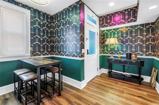 1221 N Palm Ave Unit 303, Sarasota, FL 34236 - dining area featuring wallpapered walls, baseboards, wood finished floors, recessed lighting, and an accent wall