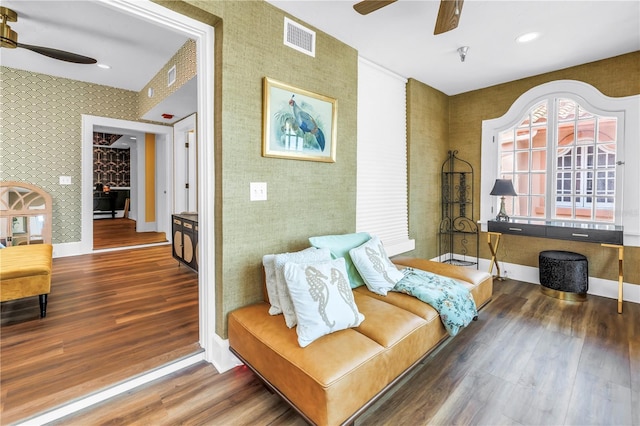 1221 N Palm Ave Unit 303, Sarasota, FL 34236 - living area featuring ceiling fan, wallpapered walls, wood finished floors, and baseboards