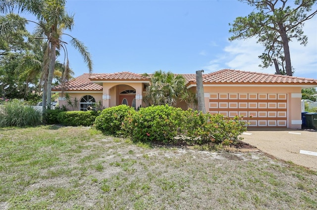 321 Sorrento Dr, Osprey, FL 34229 - mediterranean / spanish house with a garage, stucco siding, a tile roof, and concrete driveway